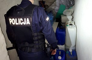 Piwnica, w której na ziemi stoją plastikowe pojemniki ze spirytusem bez polskich znaków akcyzy.