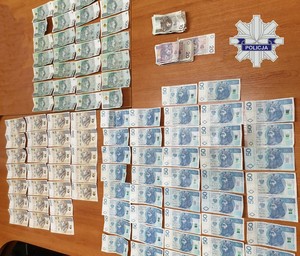 Zabezpieczona część gotówki, która rozłożona została na biurku w celu wykonania oględzin.
