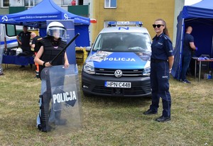 Policjantki stoją przy radiowozie.