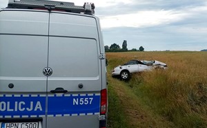 Radiowóz policyjny i rozbite na poboczu audi.