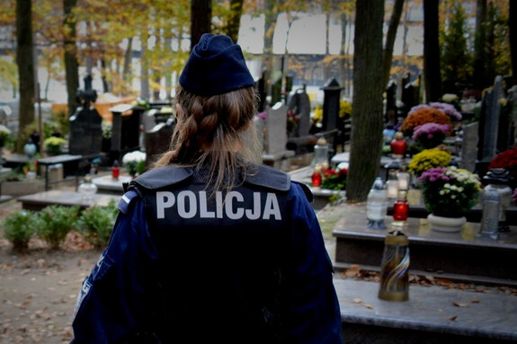 Policjantka w mundurze na cmentarzu.